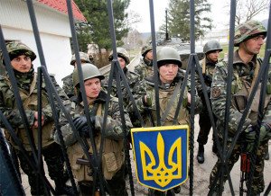Ukrainian soldiers, in front of Ukraine's national symbol, a trident