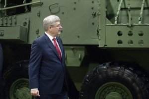 Canada's then-Prime Minister Stephen Harper walks past Light Armoured Vehicles 6.0 manufactured at General Dynamics Land Systems in London, Ontario, May 2, 2014 (Aaron Harris, Reuters)