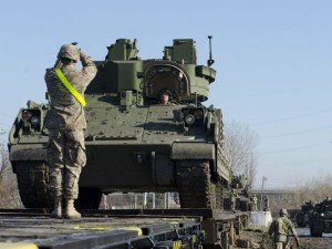 U.S.soldiers load a Bradley Fighting Vehicle onto a train in Romania on Dec 3, 2015 (U.S. Army photo)