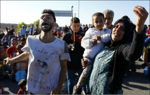 Woman holding a child reacts as Turkish police block migrants on a highway near Edirne, Turkey (file photo, Osman Orsal, Reuters)