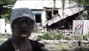 Resident of Donetsk People's Republic shows News Front the damage to her home from Ukrainian shelling in June 2016