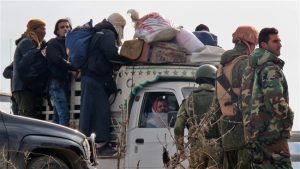 Syrians are evacuated from eastern Aleppo to territory in the west of the  city, Dec 16, 2016 (photo by AFP)