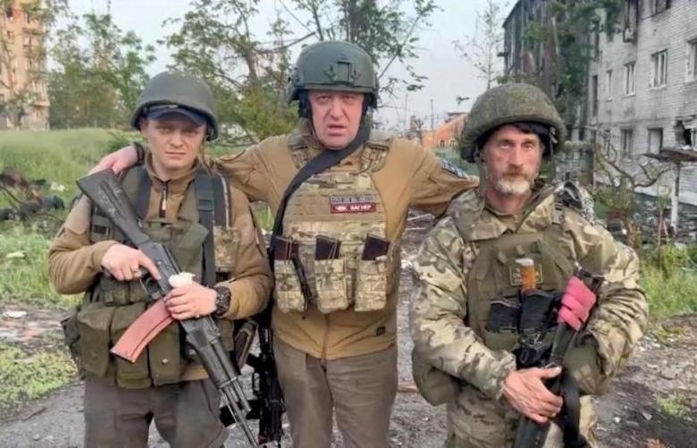 Russian oligarch Yevgeny Prigozhin [centre] poses with two Wagner Group fighters, Bakhmut in Donetsk region, Ukraine, May 25, 2023 