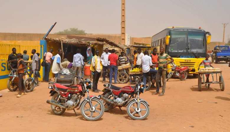 People waiting in front of the Sonitrav bus station in Filingué, Niger.
